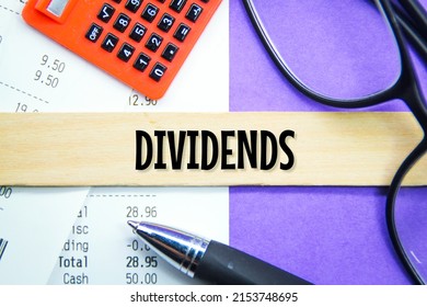 calculators, receipts, glasses with the word dividends