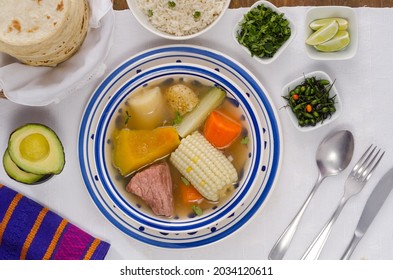 Caldo De Res, A Traditional Guatemalan Beef Soup Made With Pieces Of Meat And Vegetables Served With Rice, Vegetables And Tortillas. Top Vertical View From Above