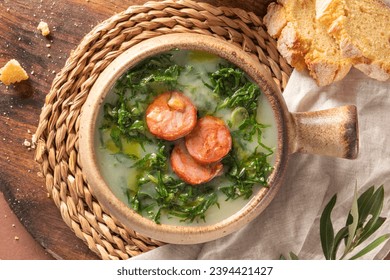 Caldo verde popular soup in Portuguese cuisine. Traditional ingredients for caldo verde are potatoes, onion, garlic, collard greens, chorizo , olive oil and salt. Is a comfort soup