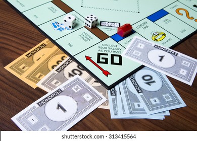 CALDWELL, IDAHO/USA - MARCH 16, 2015: Game Of Monopoly With Cash Thrown About Near The Collect Go Section