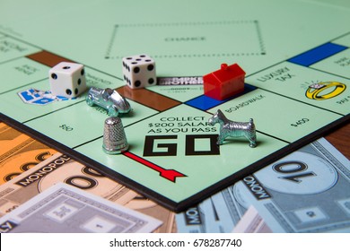 CALDWELL, IDAHO/USA - MARCH 16, 2015: Game pieces from game Monopoly sitting near the start