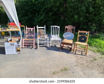 Caledonia, NS, CAN, August 6, 2022 - Chairs Set Up At A Yard Sale For Sale At The End Of A Table.