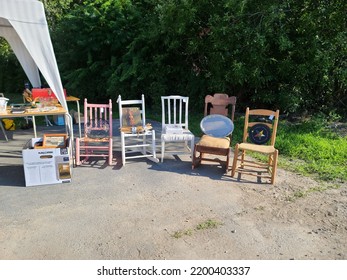 Caledonia, NS, CAN, August 6, 2022 - Chairs Set Up At A Yard Sale For Sale At The End Of A Table.