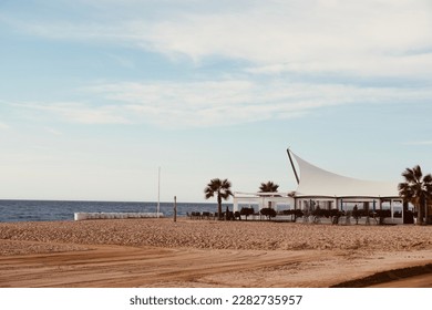 Calella beach at sunrise time with palm trees and mediterranean sea in the background. Perfect place for vacations near the touristic Costa Brava. Barcelona, Spain. - Shutterstock ID 2282735957