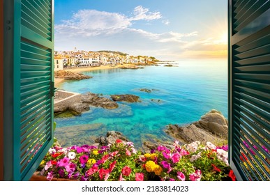 Calella De Palafrugell, Spain - June 2 2022: View Through An Open Window With Shutters Of The Whitewashed Costa Brava Village As The Sun Sets On The Catalonian Coast Of Southern Spain.