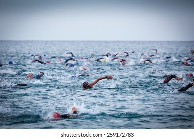 CALELLA â?? MAY 18:  Triathletes on start of the Ironman triathlon competition at Calella beach, May 18, 2014 in Calella, Spain 