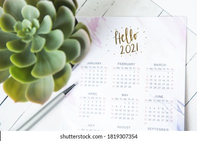 Calendar For 2021 On The Office Desk In A Notebook. Plans And Goals For The New Year. Top View Layout On Gray Background