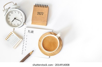 Calendar 2022 and alarm clock on office table. to-do list and plan for next year. flatlay composition