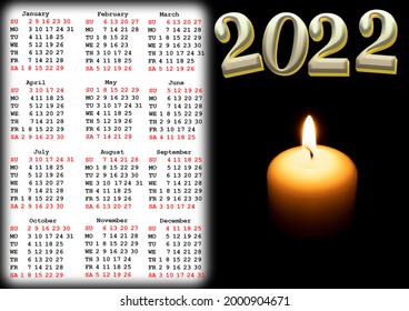 Calendar for 2022 with US holidays with a photo of a hot candle in the dark. Wall or desk calendar for 2022