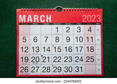 Calendar 2023, March, monthly planner. Day, month, year, date and activity organiser wall and desk planner. Red and white calendar with large letters and numbers on green background.  - Shutterstock ID 2244784001