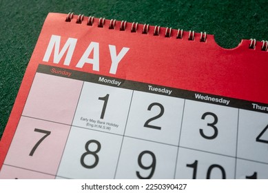Calendar 2023, May, monthly planner. Day, month, year, date and activity organiser wall and desk planner. Red and white calendar with large letters and numbers on green background. Close up. - Shutterstock ID 2250390427