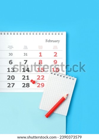 Calendar of 29 february date, notebook and pencil on blue Background. February month calendar. Leap day, leap year concept. top view. copy space. template for design