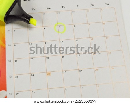 Calendar with the 5th day highlighted using a yellow highlighter