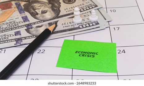 Calendar, cash, pawns, pencil, "Economic Crisis" note depicting global economic downturn, financial instability, and market trends. - Powered by Shutterstock - Get 15% off with code: PIKWIZARD15