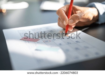 Calendar Deadline. Young Woman Holding Pen Marking Date