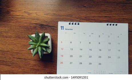 Calendar on desk. Desktop Calender 2021, pot of cactus place on office table, for Planner to set timetable, agenda, appointment, organization each date, month and year. Planner and Calendar Concept.