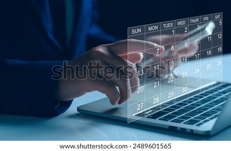 Calendar on the virtual screen interface. Businessman manages time for effective work.  Highlight appointment reminders and meeting agenda on the calendar. Schedule management concept.