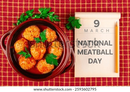 Calendar opened at the date March 9 and kottbullar meatballs in red sauce. National Meatball Day