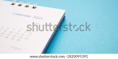 calendar page 2021 close up on blue background business planning appointment meeting concept