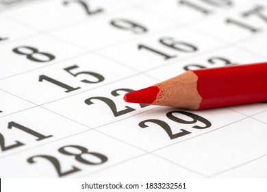 Calendar and a red pencil to mark the desired date