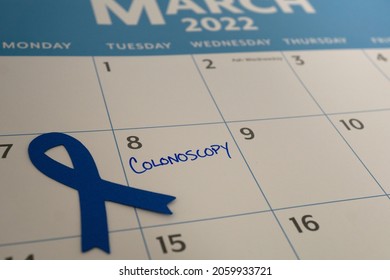 Calendar reminder for colonoscopy appointment in March, which is Colon Cancer Awareness month. The blue ribbon represents the month.
