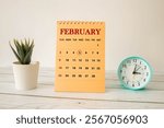 Calendar reminder event concept. Wooden cubes with numbers and month on February 5 with sunlight.