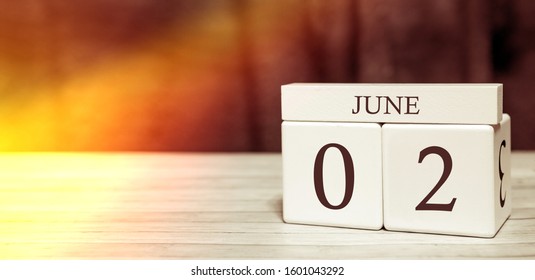 Calendar Reminder Event Concept. Wooden Cubes With Numbers And Month On June 2 With Sunlight.