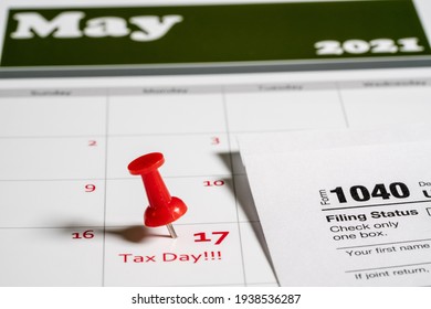 Calendar with Tax Day note inserted in the date for May 17 to illustrate the new tax return filing date of 17th May 2021. - Shutterstock ID 1938536287
