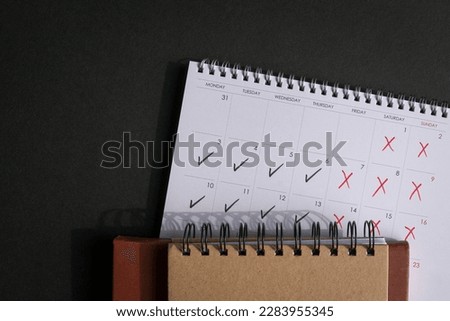 Calendar with ticks and crosses, depicting four day work week concept. Top view. Copy space.