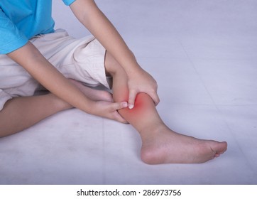 Calf Leg Pain, Child Holding Sore And Painful Muscle, Sprain Or Cramp Ache Filled With Red Bright Place. Person Injured When Exercising Or Playing.