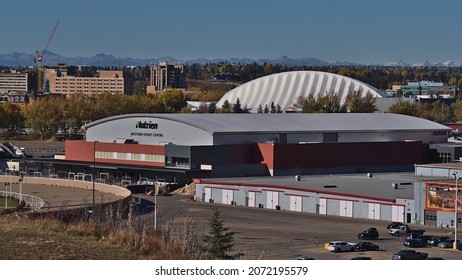 Calgary, Alberta, Canada - 10-08-2021: View of the Nutrien Western Event Centre in Calgary, part of the annual Stampede, on sunny day in autumn with Rocky Mountains in background.