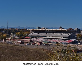 Calgary, Alberta, Canada - 10-08-2021: View of the Stampede Grandstand in Calgary, Canada, a stadium with 17,000 seats and standing room for 8,000 people in autumn with the Rockies in background.