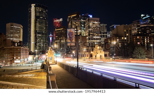 Calgary Alberta Canada, April 7 2021:\
Long exposure photograph over the Center Street Bridge of downtown\
landmarks and buildings at night in a Canadian\
City.