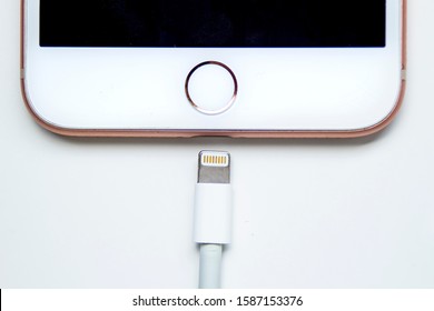 Calgary, Alberta. Canada Dec 12, 2019. Close up of an iPhone Plus and a Lightning to USB Cable. Apple is killing Lightning connector on top iPhones by 2021. Illustrative