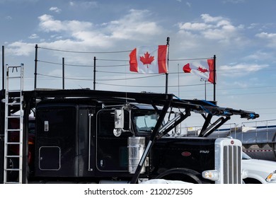 Calgary Alberta Canada, February 4 2022: A Freedom Convoy Semi Truck Supporter Parked At A Local Truck Stop Flying The Canadian Flag.