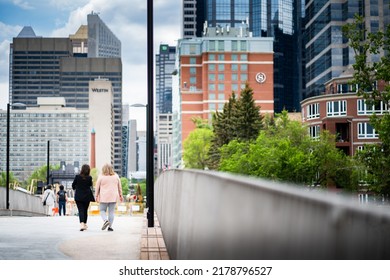 Calgary Alberta Canada, July 02 2022: People Walking Across The New Princess Island Park Jaipur Pedestrian Bridge Into The Downtown Centre.