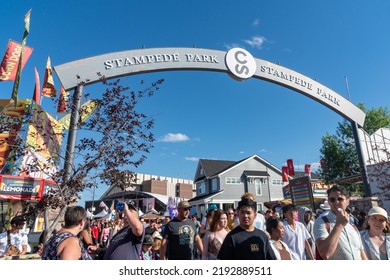 Calgary, Alberta, Canada - July 16, 2022: Crowds Of People Enter Stampede Park, The Midway Carnival Rides And Games Area