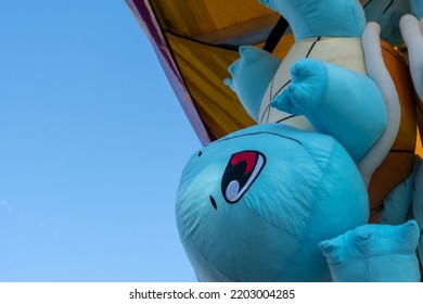 Calgary, Alberta, Canada - July 16, 2022: A Squirtle Pokemon Stuffed Plush Toy Offered As A Prize For Winning A Carnival Game, Shown Hanging Upside Down