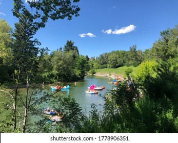 Calgary, Alberta, Canada, July 18th, 2020: Boats And People Playing Along The Elbow River. The Fun Time During COVID 19.