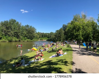 Calgary, Alberta, Canada, July 18th, 2020: Boats And People Playing Along The Elbow River. The Fun Time During COVID 19.