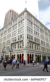 Calgary. Alberta. Canada.  June 29 2017.  Red Ball Project In Calgary Downtown, Stephen Avenue.  The Ball Was Trapped Inside Hudson Bay's Pillars.