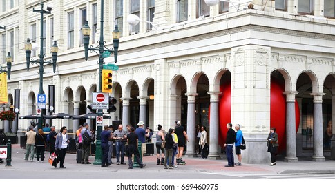 Calgary. Alberta. Canada.  June 29 2017.  Red Ball Project In Calgary Downtown, Stephen Avenue.  The Ball Was Trapped Inside Hudson Bay's Pillars.