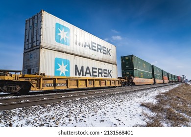 Calgary Alberta Canada, March 02 2022: A pair of Maersk shipping containers on a railway freight line.