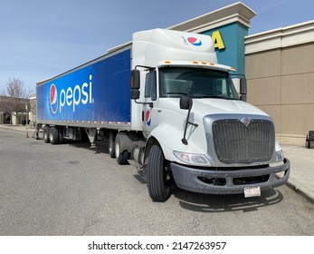 Calgary, Alberta, Canada. Monday 18, 2022. A Pepsi Cargo Truck Parked At A Mall Center During The Day.