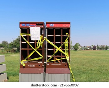 Calgary, Alberta, Canada. Sep 5, 2022. A Vandalized Targeted Community Canada Post Mailbox Break-in With Caution Safety Barricade Tape.