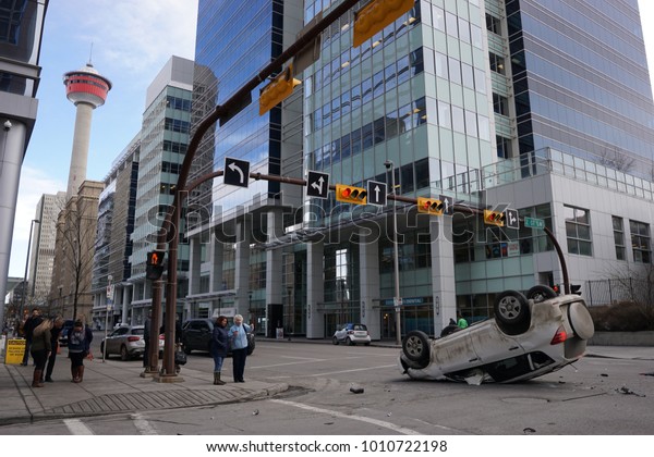 Calgary,\
Alberta/Canada - January 17, 2018: a car was involved in a traffic\
accident and flipped over.  Onlookers discussed the incident and\
speculated what may have\
happened.