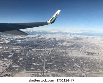 Calgary, Alberta/Canada - June 5,2020: Wing Of Westjet Plane Flying Over Calgary