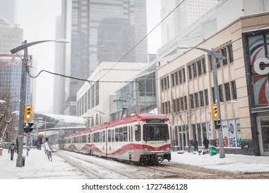 CALGARY, CANADA -  3RD MARCH 2018: Streets Of Calgary In The Winter. A Tram, Buildings, Snow And People Can Be Seen.