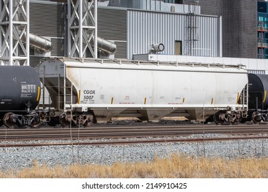 Calgary, Canada, April 18, 2022; A White Hopper Rail Car Labeled 