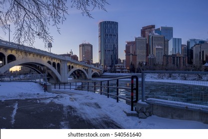 CALGARY, CANADA - DEC 17: Calgary's skyline at sunrise on a cold winter day on December 17, 2016 in Calgary, Alberta. Calgary is home to many oil companies. The Bow River is visible. 